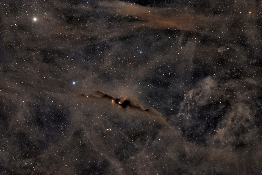 The Red Glow of the Cosmic Bat Nebula
